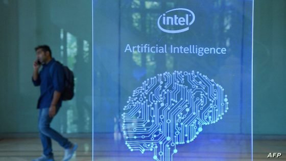 A visitor at Intel's Artificial Intelligence (AI) Day walks past a signboard during the event in the Indian city of Bangalore on April 4, 2017. (Photo by MANJUNATH KIRAN / AFP)